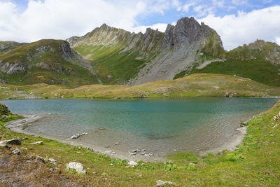 Scenic view of lake and mountains against sky