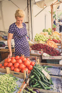 Woman standing at market stall