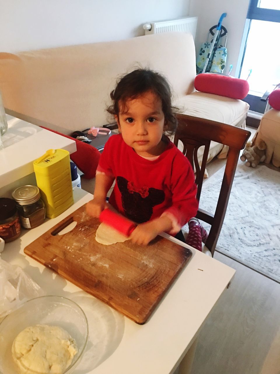 domestic room, indoors, childhood, one person, front view, domestic life, leisure activity, domestic kitchen, home interior, looking at camera, child, real people, lifestyles, kitchen, people, food, day, mixing, adult