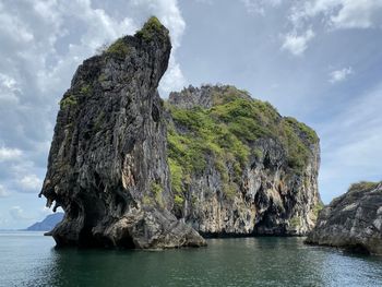 Rock formation in sea against sky