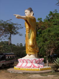 Statue of buddha against trees