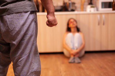 Portrait of young woman sitting on hardwood floor