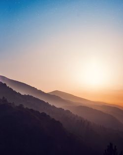 Scenic view of mountains against sky during sunset