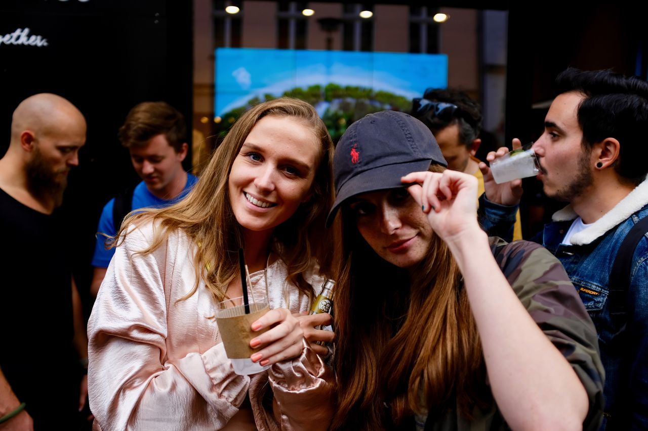 real people, leisure activity, togetherness, enjoyment, friendship, lifestyles, men, smiling, large group of people, night, young women, outdoors, young adult