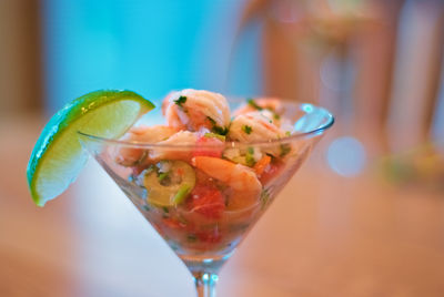 Close-up of seafood in wineglass indoors