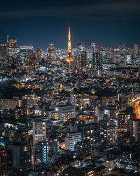 Illuminated cityscape against sky at night