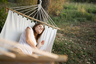 Low section of woman sitting on hammock