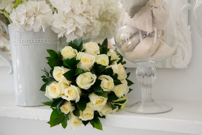 Close-up of white roses in vase on table
