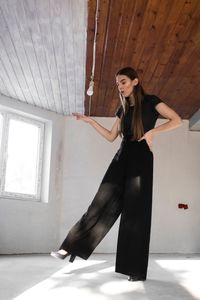 Portrait of woman standing against ceiling