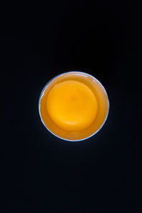 Directly above shot of orange juice against black background