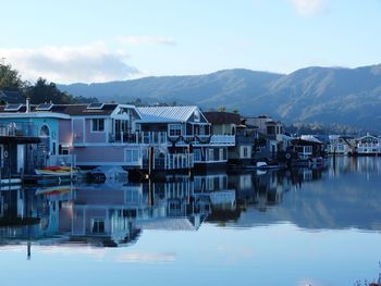 Reflection of buildings in lake against sky