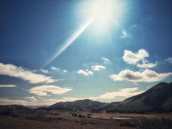 Scenic view of mountains against sky on sunny day