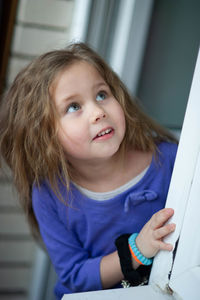 Adorable little girl against the large window