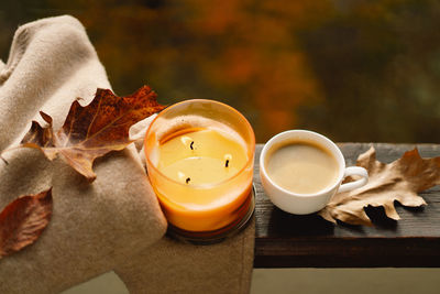 Sweater, candle, hot coffee and autumn decor. autumn home decor