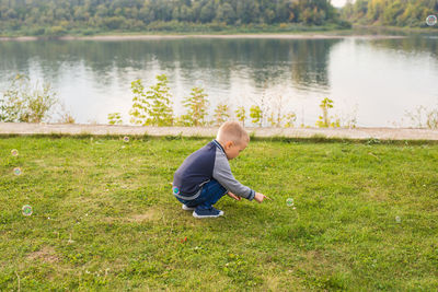 Rear view of boy in lake