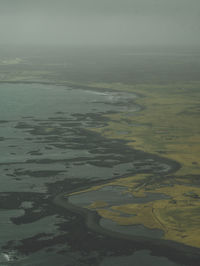 High angle view of sea shore against sky