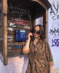 Young woman wearing sunglasses standing outdoors