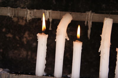 Close-up of candles burning in temple