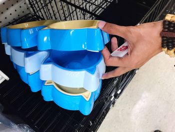 Close-up of hand holding blue cup