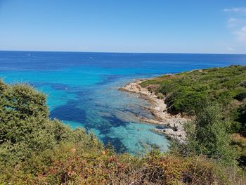 Scenic view of sea against blue sky