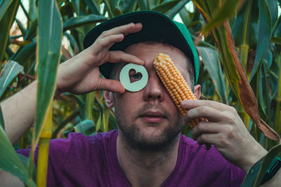 Close-up of man holding corn
