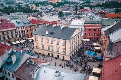 Aerial view of people on street amidst buildings in city