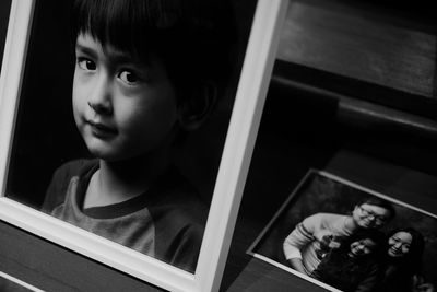 Picture frames of family on table