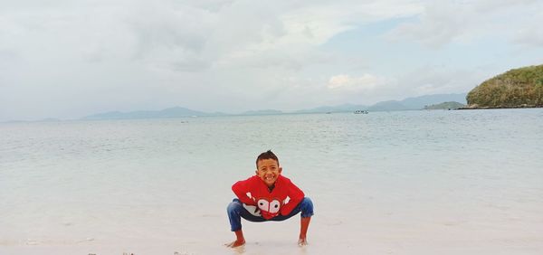 Portrait of man on beach against sky