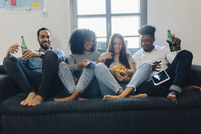 Happy friends sitting on the sofa