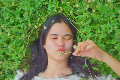 Portrait of young woman holding food outdoors