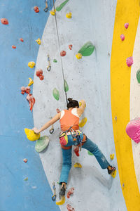 Woman climbing on wall