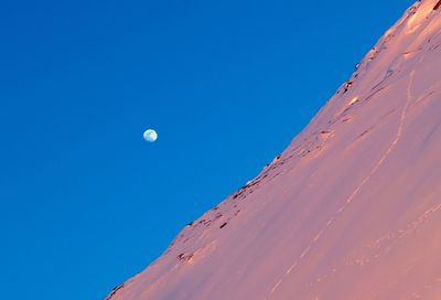 Scenic view of moon against blue sky