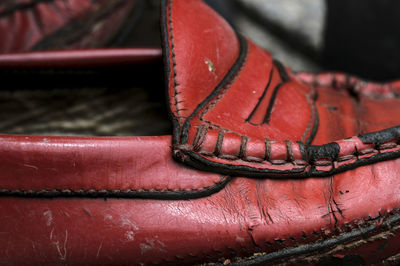 Close-up low section of old shoes on floor