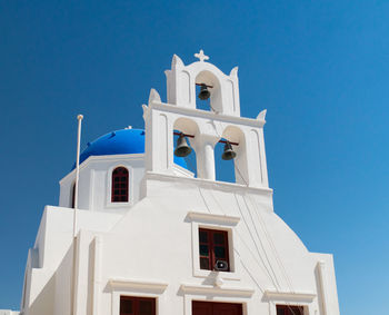 Low angle view of building against clear blue sky