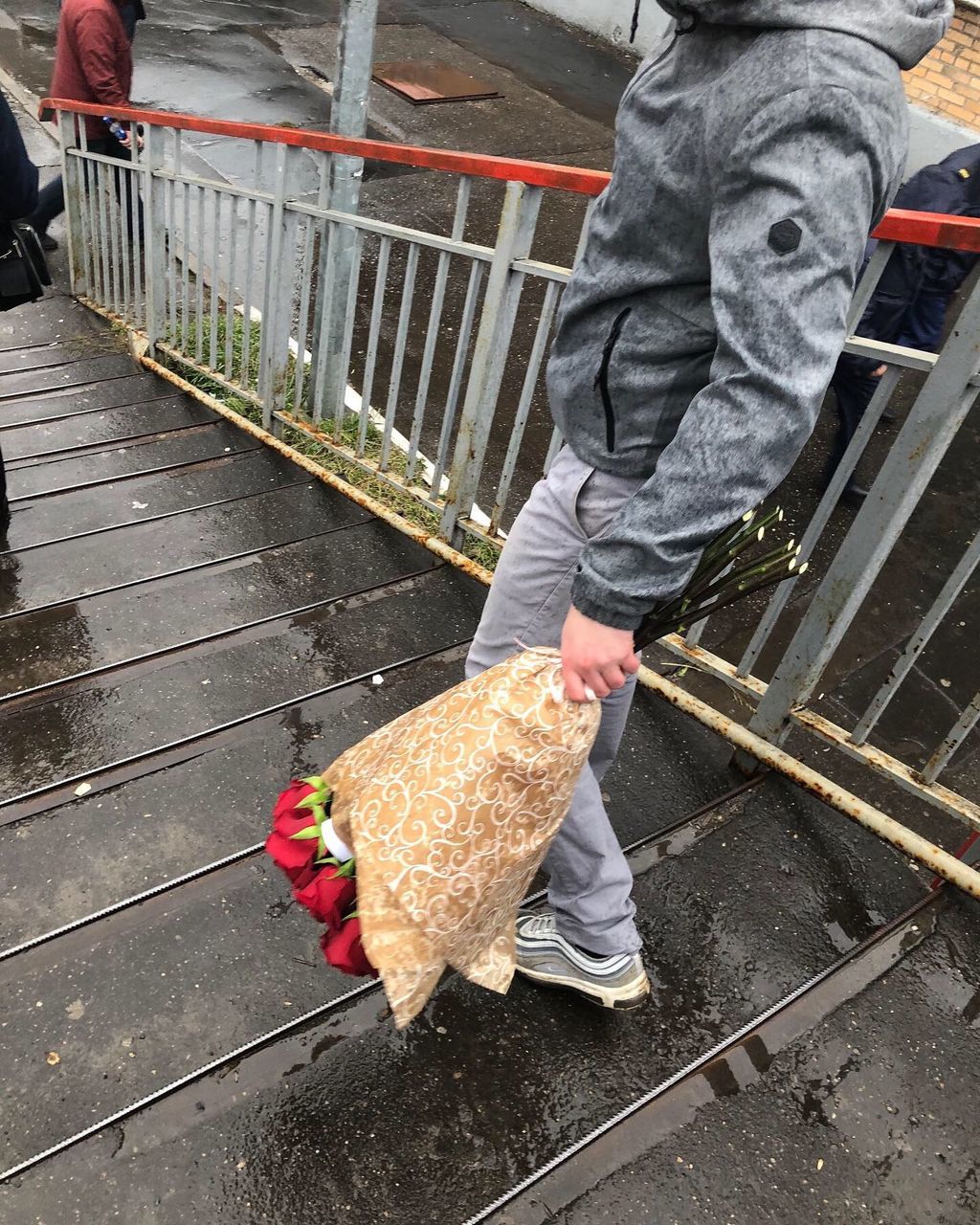 LOW SECTION OF MAN STANDING ON RAILING