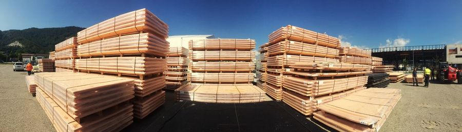 Stack of palettes against clear blue sky