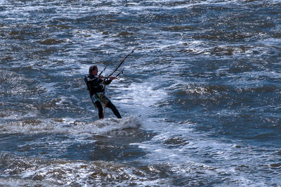 Woman jumping in sea