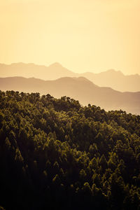 Scenic view of mountains against sky at sunset