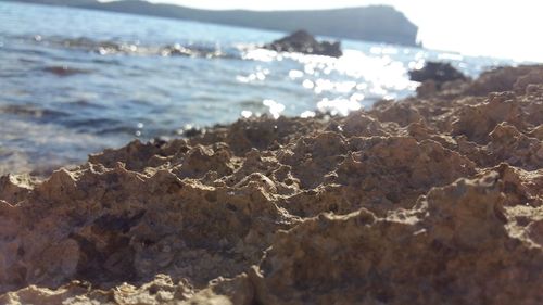 Close-up of wave on beach against sky