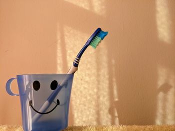 Close-up of electric lamp against wall at home