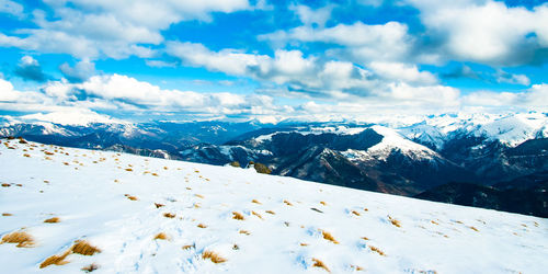 Scenic view of mountains against blue sky