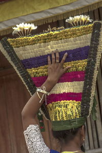 Midsection of woman holding flowers