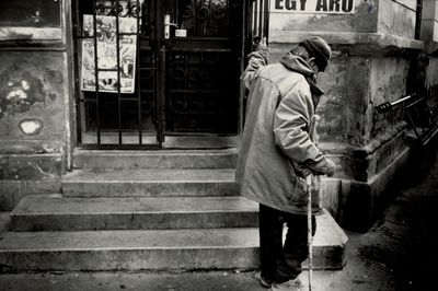 Side view of senior man moving up on steps