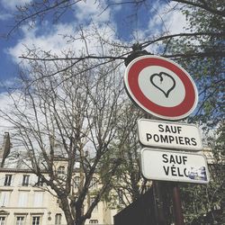 Low angle view of road sign against sky