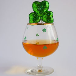 Close-up of wineglass on table against white background