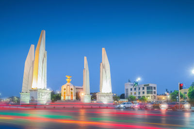 Illuminated buildings against blue sky