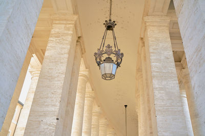 Low angle view of pendant light hanging on wall in building