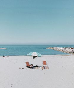 Scenic view of beach against clear sky