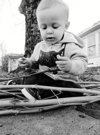 Cute boy sitting outdoors