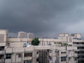 Residential buildings in city against sky